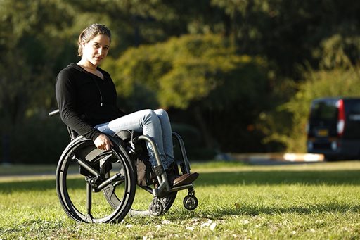 Woman in wheelchair in field