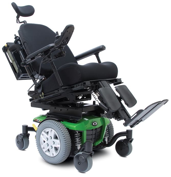 A modern electric wheelchair with a green base, large gray wheels, and black cushioned seat. The seat and leg rest are tilted back and elevated, highlighting its Power Tilt system for adjustable reclining and footrest features.